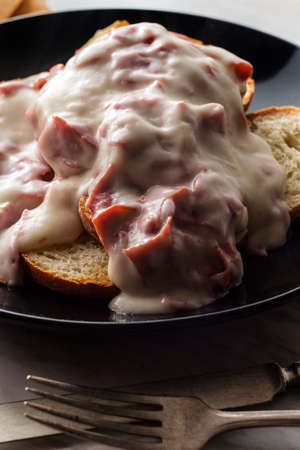 Creamed and chipped beef on sliced toast on marble kitchen table also known as S.O.S.