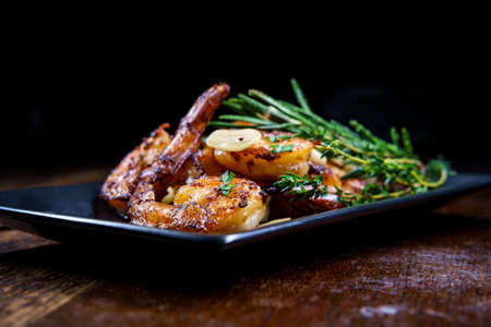 Authentic Portuguese Garlic Shrimp garnished with rosemary and thymeの写真素材