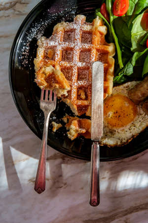Belgian waffle breakfast served with sausage eggs and coffee