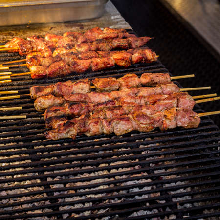 Chicken kebabs roasting on the grill at carnival fairground street vendorの写真素材