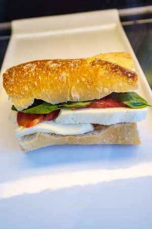Caprese sub sandwich on hard roll with fresh sliced mozzarella basil and tomatoesの写真素材