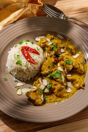 Indian chicken korma curry dinner with basmati rice and almondsの写真素材