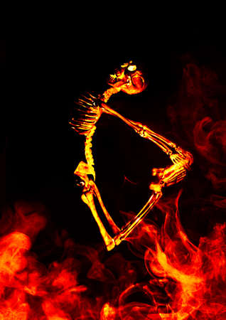 Scary demon Halloween skeleton dances in deadly fireの写真素材