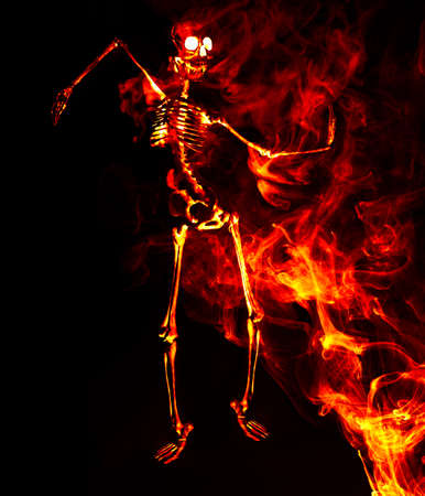 Scary demon Halloween skeleton dances in deadly fireの写真素材