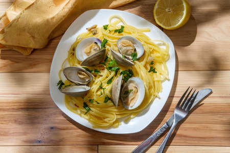 Linguine with littleneck white wine clam sauce and parsley garnish