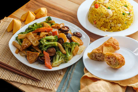 Buddha's delight sauteed mixed chinese vegetables with tofu served with chicken fried rice and an egg rollの写真素材