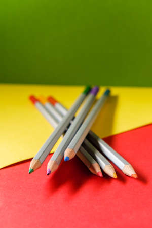 Vibrant artist colored pencils still life with paper background