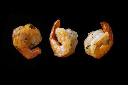Stir frying and tossing shrimp floating in air closeupの写真素材
