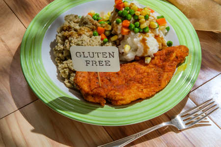 Soul food buttermilk fried chicken breast with creamy mashed potatoes stuffing and mixed steamed...