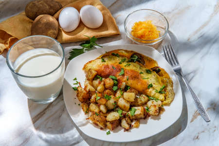 American breakfast mushrooms and cheddar cheese omelette with home fries and milk