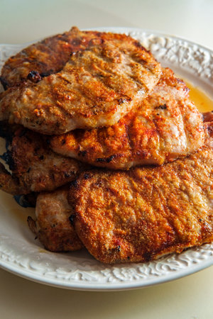 Grilled porkchops marinated in honey glaze on server platter
