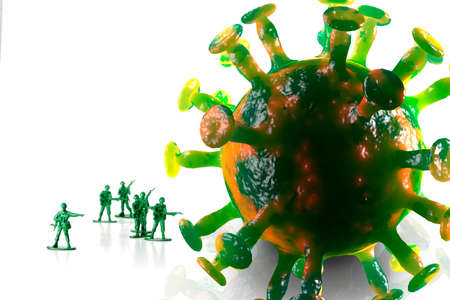 Green toy army men attack and fight off the coronavirus as metaphor for human immune systemの写真素材