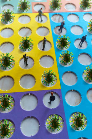 Miniature businessmen practicing social distancing to slow the spread of the deadly coronavirusの写真素材