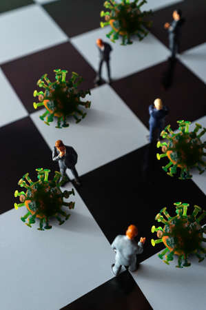 Miniature businessmen practicing social distancing to slow the spread of the deadly coronavirusの写真素材