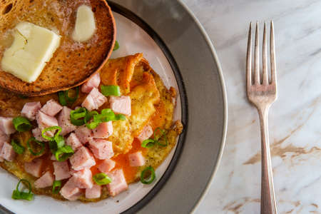 Diced ham and cheddar cheese American breakfast omeletteの写真素材