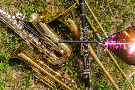 Musical instruments including trombone trumpet clarinet and saxophone unzip to reveal neon soundwaveの写真素材