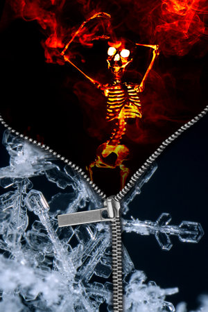 Opposites hot verus cold with macro snowflakes and skeleton on fireの写真素材