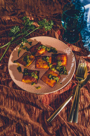 Lightly fried Italian meat raviolis with fresh pesto sauce