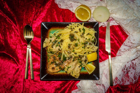 Italian chicken piccata linguine with artichoke hearts and capersの写真素材