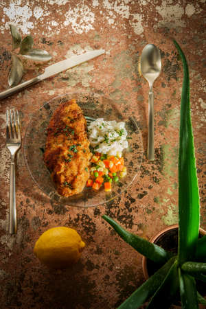 Southern fried chicken cutlets with mashed potatoes and vegetablesの写真素材