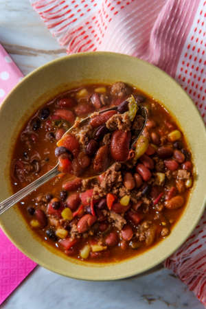 Beef chili con carne dinner with fun pink decorative napkinsの写真素材