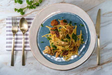 Italian spicy hot sausage and linguine with alfredo olive sauce and artichoke heartsの写真素材