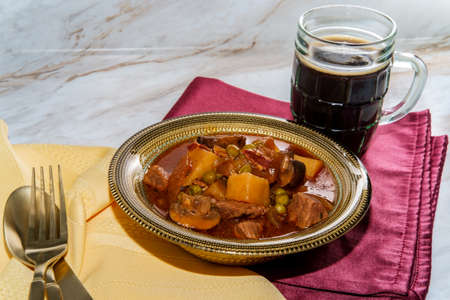 Authentic Irish beef beer stew with mushrooms and peas