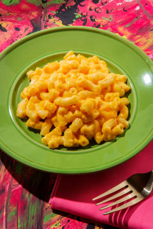 Stylized pop fashion macaroni and cheese on abstract pink backgroundの写真素材