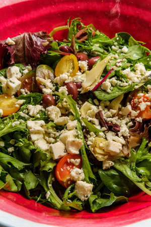 Blue cheese Mediterranean salad with multicolored tomatoes kalamata olives and artichoke heartsの写真素材