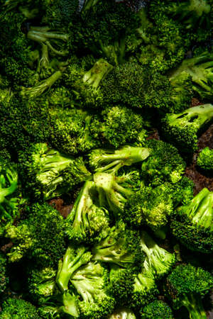 Broccoli florets on baking pan seasoned with salt pepper and olive oilの写真素材