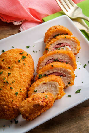 Chicken cordon bleu served with steamed broccoliの写真素材