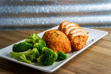 Chicken cordon bleu served with steamed broccoliの写真素材