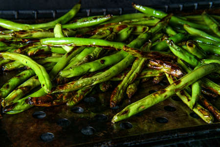 BBQ garlic seasoned green beans cooking in propane grillの写真素材