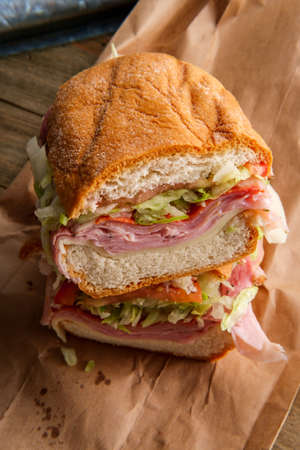 Italian sub sandwich with provolone cheese ham prosciuttini cappacuolo salami and pepperoniの写真素材