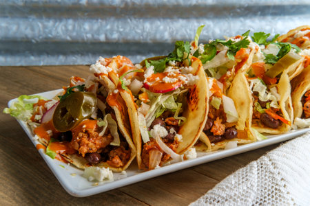 Mexican chorizo sausage black bean tacos with queso fresco jalapenos and chipotle salsa cremosaの写真素材