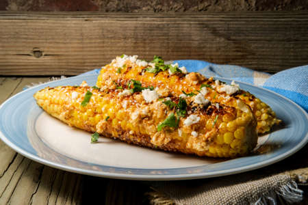 Mexican street corn also known as elote served with chili mayonnaise and cotija cheese