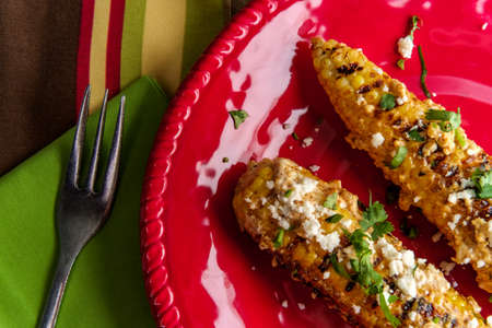 Mexican street corn also known as elote served with chili mayonnaise and cotija cheese