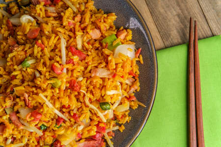 Chinese pork fried rice with wooden chopsticksの写真素材