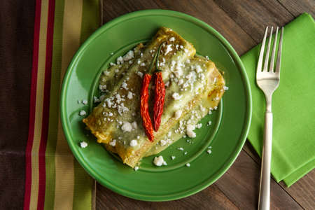 Mexican enchiladas with creamy poblano pepper sauce and queso fresco cheeseの写真素材