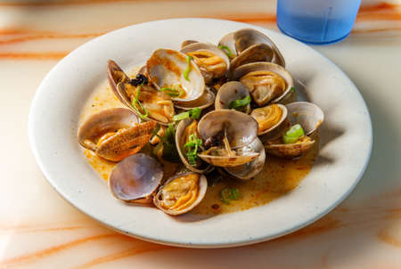 Chinese clams with black bean sauce garnished with green onions