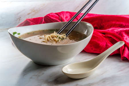 Japanese miso ramen noodle soup with tuxedo sesame seeds and sliced scallions for garnish