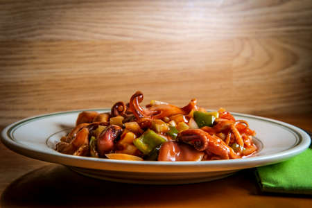 Spicy asian barbecue baby octopus salad with vegetables