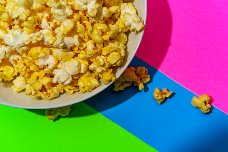Movie theater popcorn on colorful neon pop art background