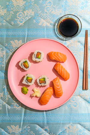 Combination Japanese Atlantic salmon sushi and nigiri with pickled ginger and wasabi shot with hard lightの写真素材