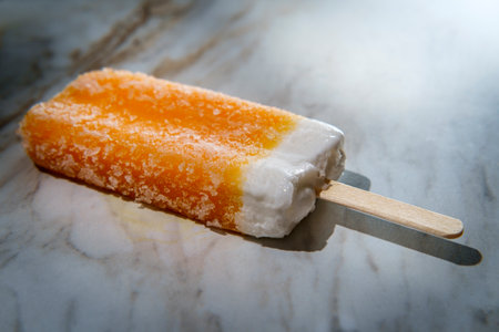 Refreshing frozen dessert Orange and cream ice pop on a stick