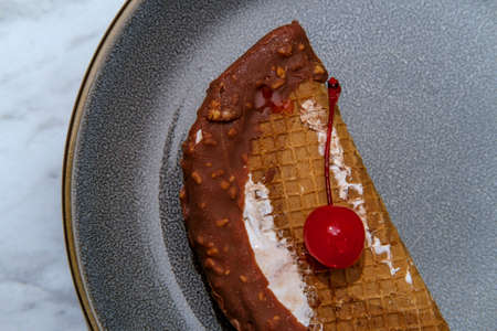 Taco icecream sandwich with maraschino cherry on top