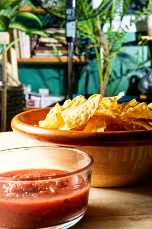 Mexican crispy tortilla chips with spicy red tomato salsaの写真素材