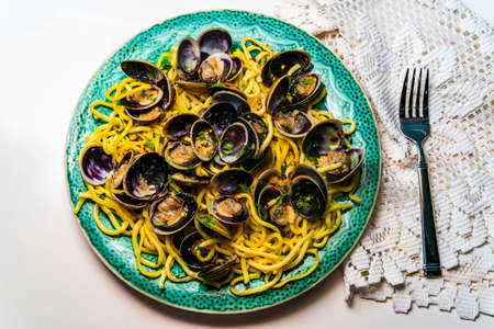 Linguine with littleneck white wine clam sauce and parsley garnish