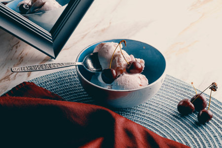 Bowl of delicious black cherry icecream on marble kitchen counterの写真素材