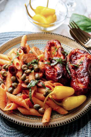 Penne alla zingara with Italian pink vodka sauce and mozzarella cheese  stuffed sausage with pickled yellow chili peppersの写真素材